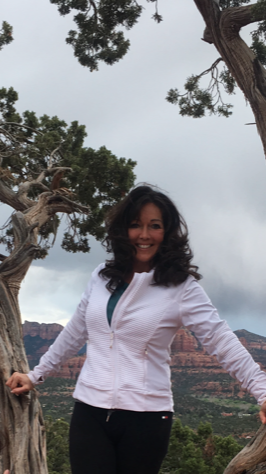 Image shows the founder of Neurosox, Donna Marshall smiling in an outdoor setting surrounded by trees