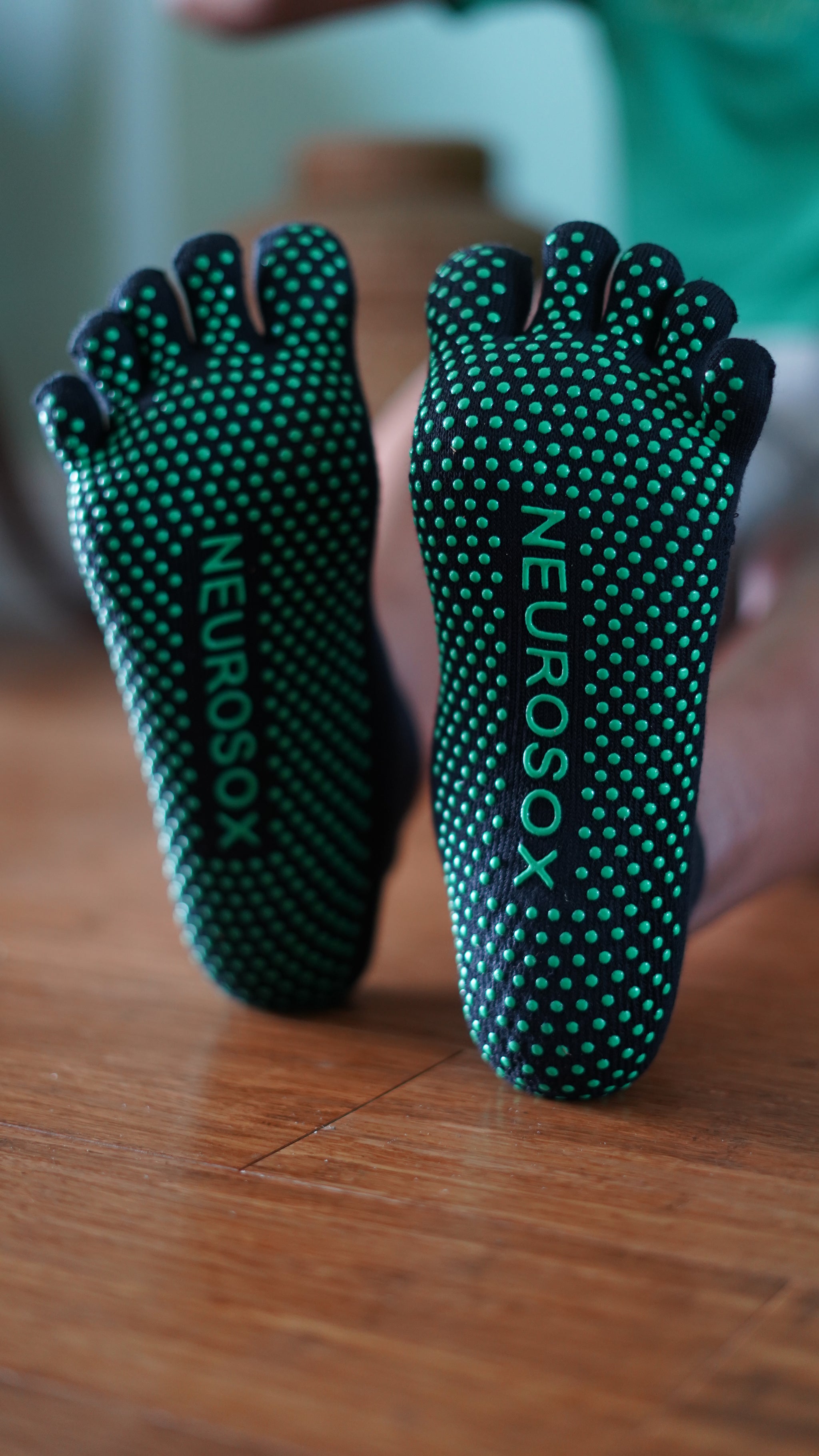 Close-up of NeuroSox five toe socks highlighting breathable fabric and silicon grip	