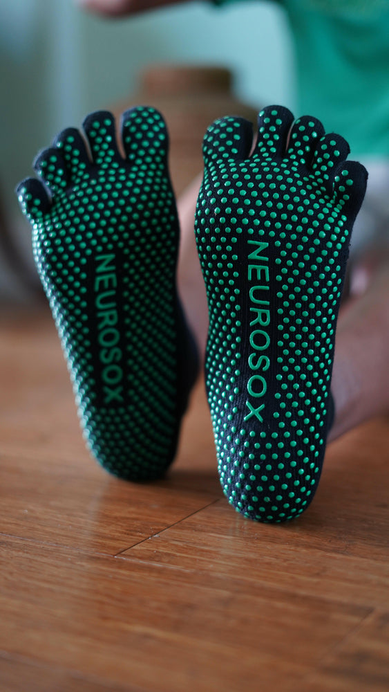 Close-up of NeuroSox five toe socks highlighting breathable fabric and silicon grip	