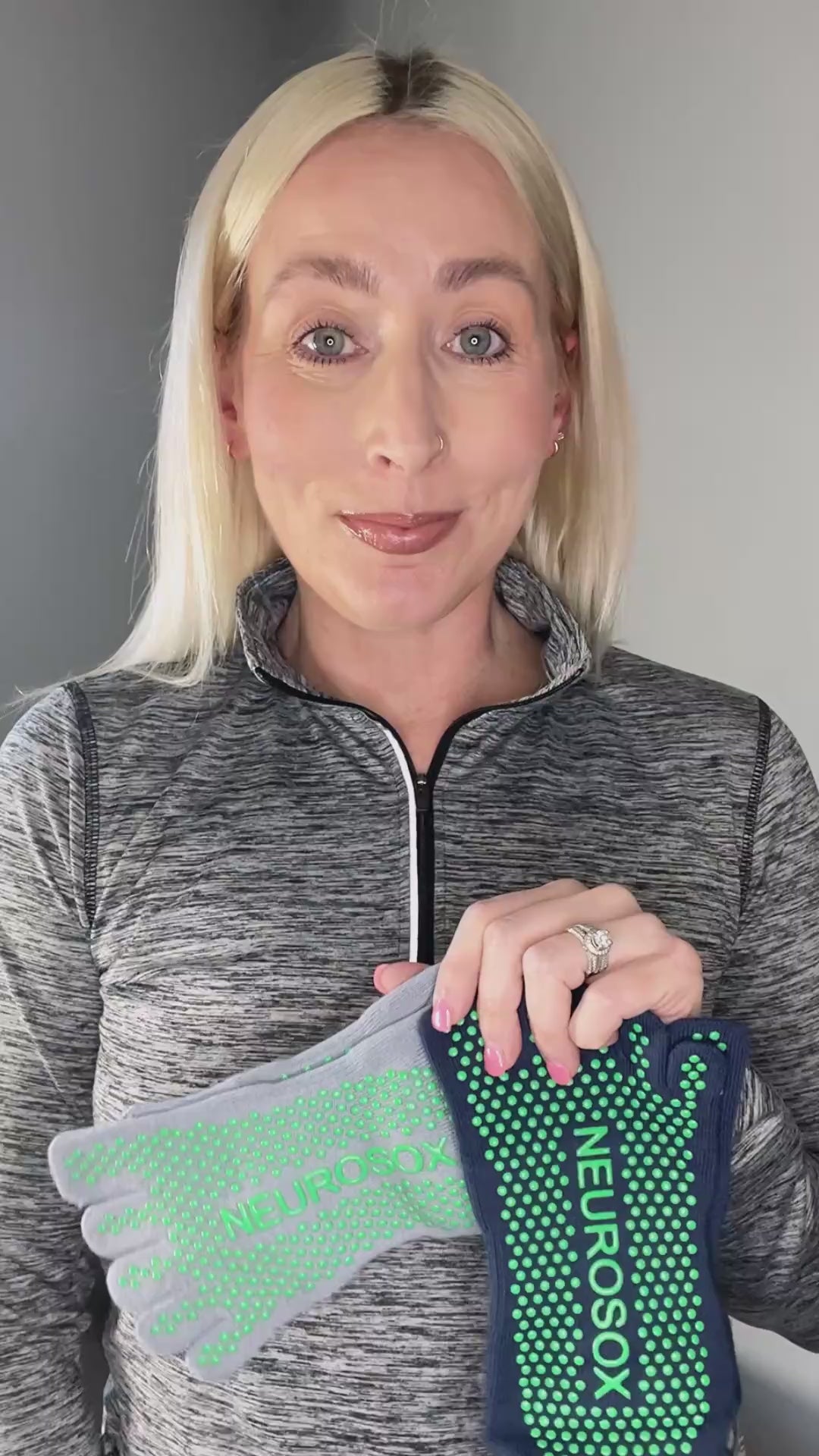 
                  
                    Load and play video in Gallery viewer, Woman wearing black five-toe grip socks doing yoga on wood floor, showing sock fit and non-slip design.
                  
                
